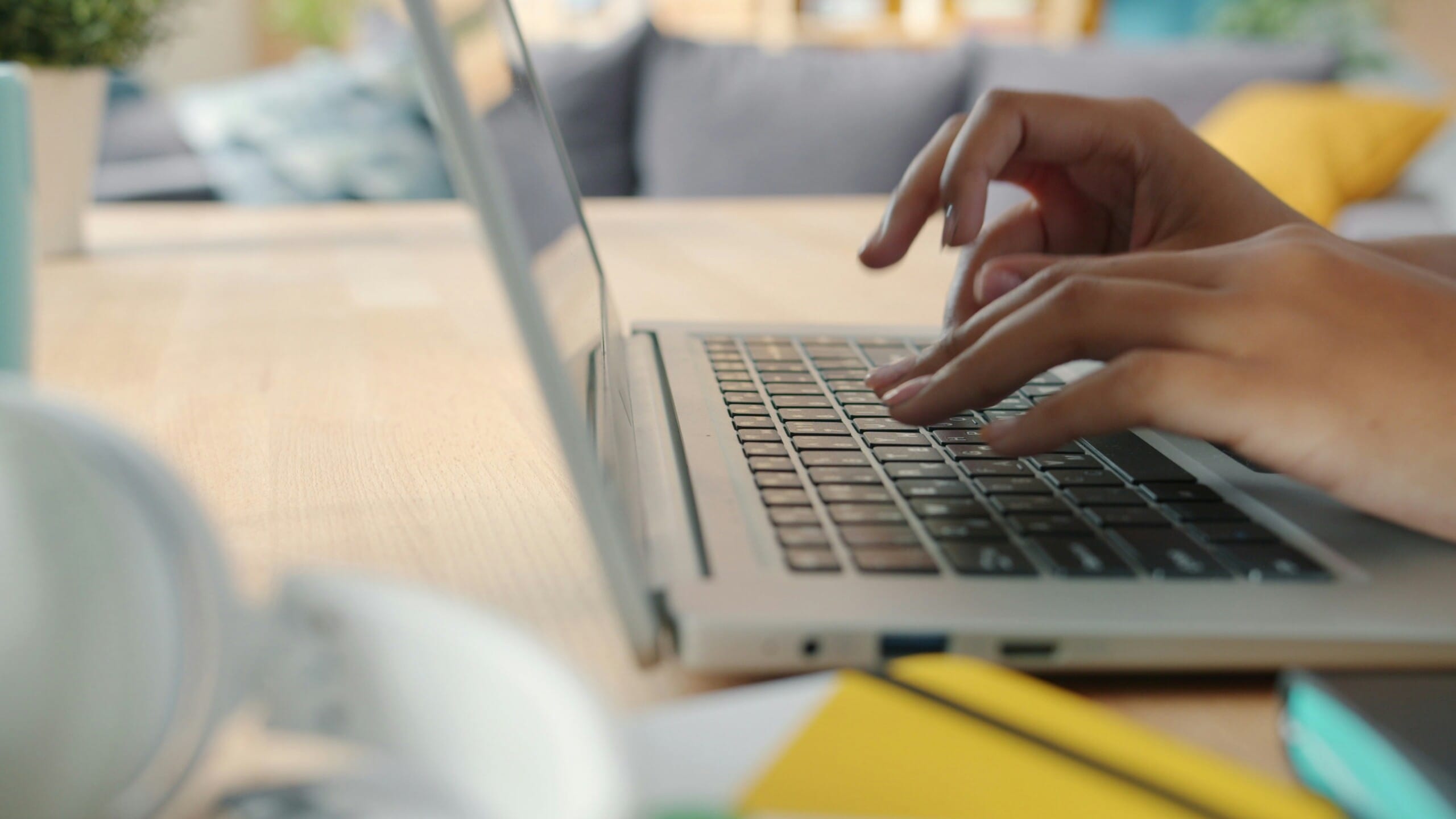 hands typing on a keyboard implying school from home